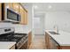 A lovely kitchen featuring stainless steel appliances, granite countertops, and light wood cabinets at 2116 Chambers Rd, Brighton, CO 80601