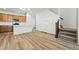 An inviting kitchen and living area showcasing hardwood floors, modern appliances, and a breakfast bar at 2116 Chambers Rd, Brighton, CO 80601