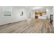 Bright and open living space with hardwood floors and lots of natural light that connects to the kitchen at 2116 Chambers Rd, Brighton, CO 80601