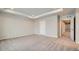 Large main bedroom with tray ceiling, neutral carpet, and ensuite bathroom at 2116 Chambers Rd, Brighton, CO 80601