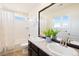 Well-lit bathroom with double sinks, granite counters, and modern fixtures creating a spa-like experience at 10554 Casper Pt, Parker, CO 80134