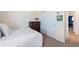 Bedroom with white comforter, dark dresser, closet, and view to the next room at 10554 Casper Pt, Parker, CO 80134