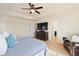 A spacious bedroom with a ceiling fan, large window, TV, and walk-in closet at 10554 Casper Pt, Parker, CO 80134