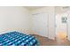 Bedroom with patterned bedding, neutral walls, and closet with sliding doors at 10554 Casper Pt, Parker, CO 80134