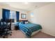 Comfortable bedroom featuring a cozy bed, desk, carpeted floors, and blue accents at 10554 Casper Pt, Parker, CO 80134