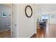 Foyer featuring hardwood floors and a decorative mirror, adjacent to a powder room at 10554 Casper Pt, Parker, CO 80134