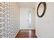 Bright entryway with patterned wallpaper and hardwood floors, creating a welcoming entrance to the home at 10554 Casper Pt, Parker, CO 80134