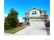 Well-maintained two-story home with a cozy front porch and blue sky at 10554 Casper Pt, Parker, CO 80134