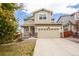 Charming two-story home boasts a welcoming porch and an attached two-car garage at 10554 Casper Pt, Parker, CO 80134