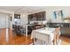 Open concept kitchen with granite countertops, stainless steel appliances, dark cabinetry, and adjacent dining area at 10554 Casper Pt, Parker, CO 80134