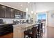 Spacious kitchen with dark cabinets, granite countertops, stainless steel appliances, and a breakfast bar with seating at 10554 Casper Pt, Parker, CO 80134