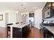 Open kitchen featuring a large island with granite countertops, dark cabinets, and stainless steel appliances at 10554 Casper Pt, Parker, CO 80134
