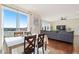 Bright open living space showcasing large windows with scenic views and modern gray couch at 10554 Casper Pt, Parker, CO 80134