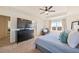 Spacious bedroom features a dresser and ceiling fan and seating at 10554 Casper Pt, Parker, CO 80134