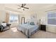 Large bedroom with a ceiling fan, seating, and a view of the outside at 10554 Casper Pt, Parker, CO 80134