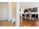 Convenient mudroom area with a bench and coat hooks, leading into the kitchen with an island at 10554 Casper Pt, Parker, CO 80134