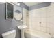 Simple bathroom featuring a pedestal sink and tiled shower/tub combo, providing essential amenities at 2280 S Decatur St, Denver, CO 80219
