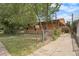 Charming single-story home with a fenced yard and covered front porch, perfect for enjoying outdoor living at 2280 S Decatur St, Denver, CO 80219