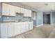 Functional kitchen with white cabinets and a convenient layout, ready for your personal touch at 2280 S Decatur St, Denver, CO 80219