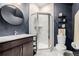 Elegant bathroom featuring a modern vanity, glass-enclosed shower, and stylish fixtures at 6776 Navajo Way, Denver, CO 80221
