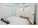 Bright bedroom featuring wood flooring, modern lighting, closet, and ensuite bathroom at 6776 Navajo Way, Denver, CO 80221