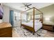 Bright bedroom with a canopy bed, large windows, modern ceiling fan, and stylish decor at 6776 Navajo Way, Denver, CO 80221