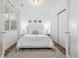 Serene bedroom featuring a plush bed, stylish decor, natural light, and closet at 6776 Navajo Way, Denver, CO 80221