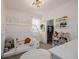 Bright and playful bedroom with a cute house bed, colorful decorations, and ample storage at 6776 Navajo Way, Denver, CO 80221