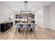 Elegant dining area with a wooden table and stylish chairs next to a modern kitchen with stainless steel appliances at 6776 Navajo Way, Denver, CO 80221