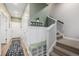 Inviting entryway features a storage bench with coat hooks and carpeted stairs leading to the upper level at 6776 Navajo Way, Denver, CO 80221