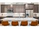 Modern kitchen with stainless steel appliances, a white countertop island, and pendant lighting at 6776 Navajo Way, Denver, CO 80221