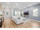 Bright living room with a modern fireplace, large windows, and comfortable seating area at 6776 Navajo Way, Denver, CO 80221