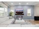 Modern living room with a sleek fireplace, large windows, and comfortable white sectional sofa at 6776 Navajo Way, Denver, CO 80221