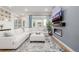 Bright living room with a modern fireplace, large windows, and comfortable white sectional sofa at 6776 Navajo Way, Denver, CO 80221