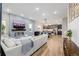 Open-concept living space with a modern fireplace, comfortable seating, and access to the dining area and kitchen at 6776 Navajo Way, Denver, CO 80221
