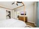 Main bedroom featuring a hardwood floor, minimalist furniture and decor, and a closet with a wardrobe at 6776 Navajo Way, Denver, CO 80221