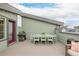 Rooftop deck featuring an outdoor dining table, modern grill, and comfortable wicker furniture at 6776 Navajo Way, Denver, CO 80221