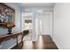 Elegant entryway with hardwood floors and an ornate console table at 15750 Willow Way, Brighton, CO 80602