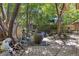 Backyard with stone patio, mature trees and eclectic decor at 901 S Leyden St, Denver, CO 80224