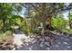 Landscaped backyard with stone path leading to covered pergola at 901 S Leyden St, Denver, CO 80224
