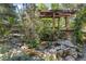 Charming backyard water feature surrounded by mature trees and lush landscaping at 901 S Leyden St, Denver, CO 80224