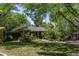 Quaint backyard with lush greenery, colorful flowers, and a charming covered patio at 901 S Leyden St, Denver, CO 80224