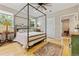 Cozy bedroom featuring a four-poster bed, hardwood floors, and natural light from the windows at 901 S Leyden St, Denver, CO 80224