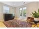 Cozy bonus room with hardwood floors, french doors, and a comfortable rocking chair at 901 S Leyden St, Denver, CO 80224