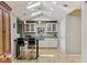 Bright kitchen with skylights, pendant lights, white cabinetry, and breakfast bar at 901 S Leyden St, Denver, CO 80224