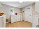 Functional laundry room with storage cabinets, water heater, and door to the outside at 901 S Leyden St, Denver, CO 80224