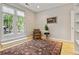 Bright living room with beautiful area rug, light wood floors, and french doors to the outdoors at 901 S Leyden St, Denver, CO 80224