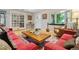 Comfortable living room featuring a large coffee table, hardwood floors, and a window bench seat at 901 S Leyden St, Denver, CO 80224