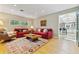 Bright living room featuring hardwood floors, large window, comfortable seating, and view to the kitchen at 901 S Leyden St, Denver, CO 80224