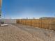 The backyard is private with a wood and white fence surrounding the gravel yard at 4987 N Walden Way, Denver, CO 80249